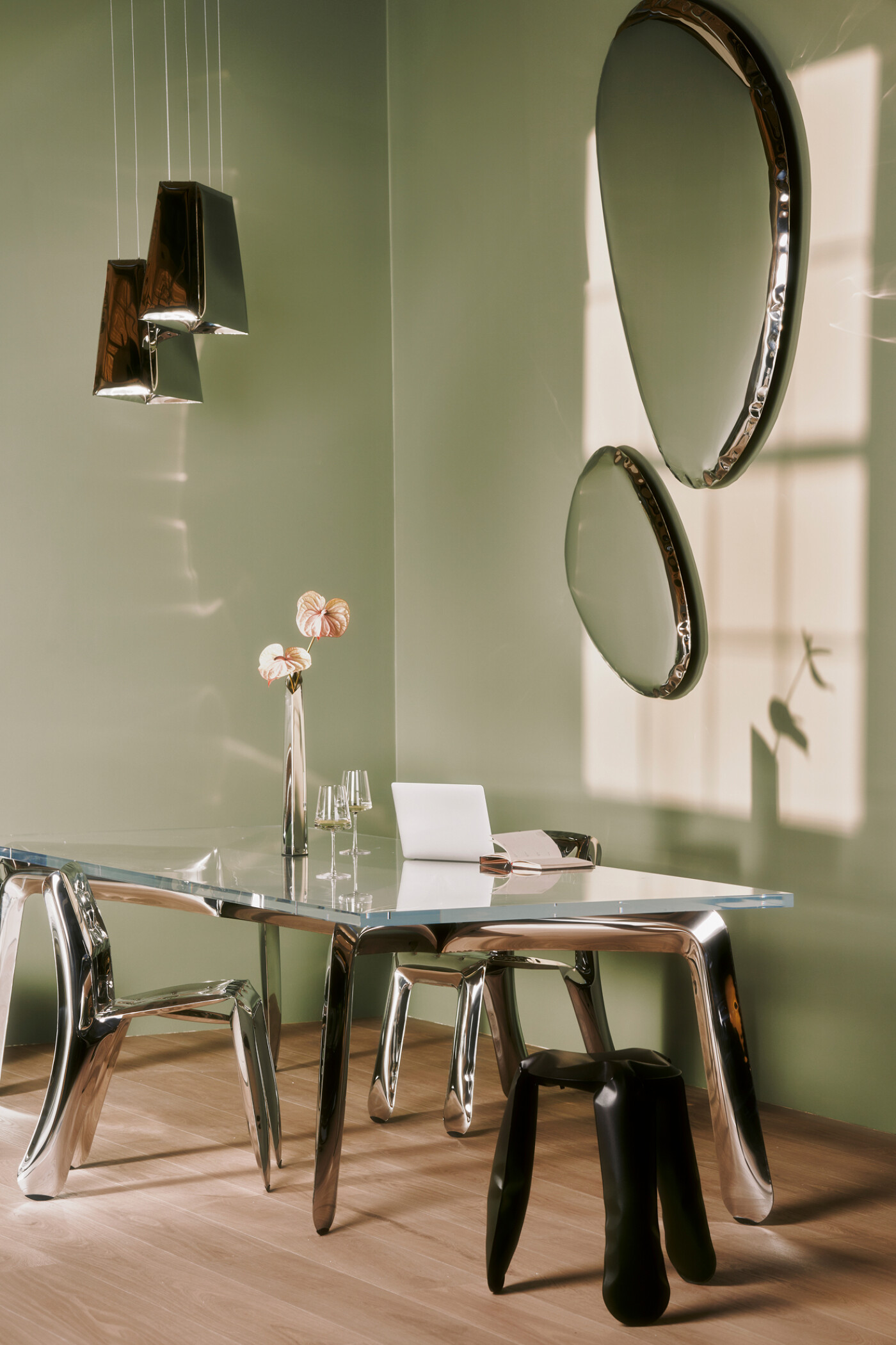 Zieta Studio, Ploop stools in polished inox and black glossy, G-Table glass top with sculptural legs, Tafla C mirrors in stainless steel, OKO vase, Quadrant pendant lamps, modern workspace setup, reflective furniture, contemporary interior design