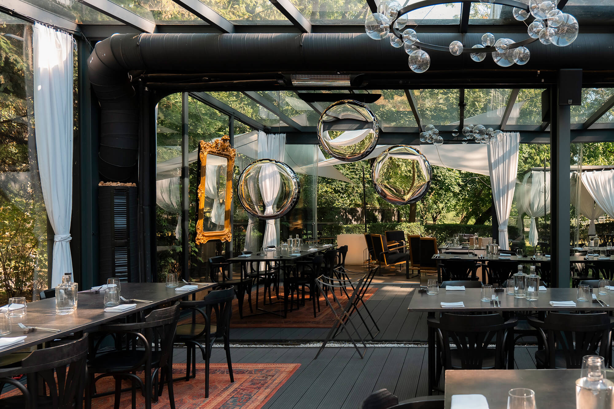 Zieta steel oko mirrors Inox hanging in a restaurant