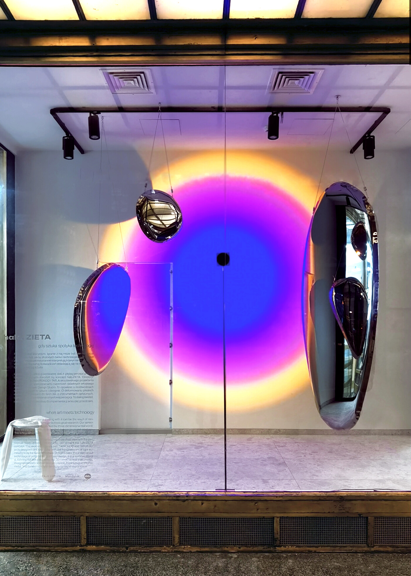 Zieta's tafla o mirrors with a colorful lights behind them