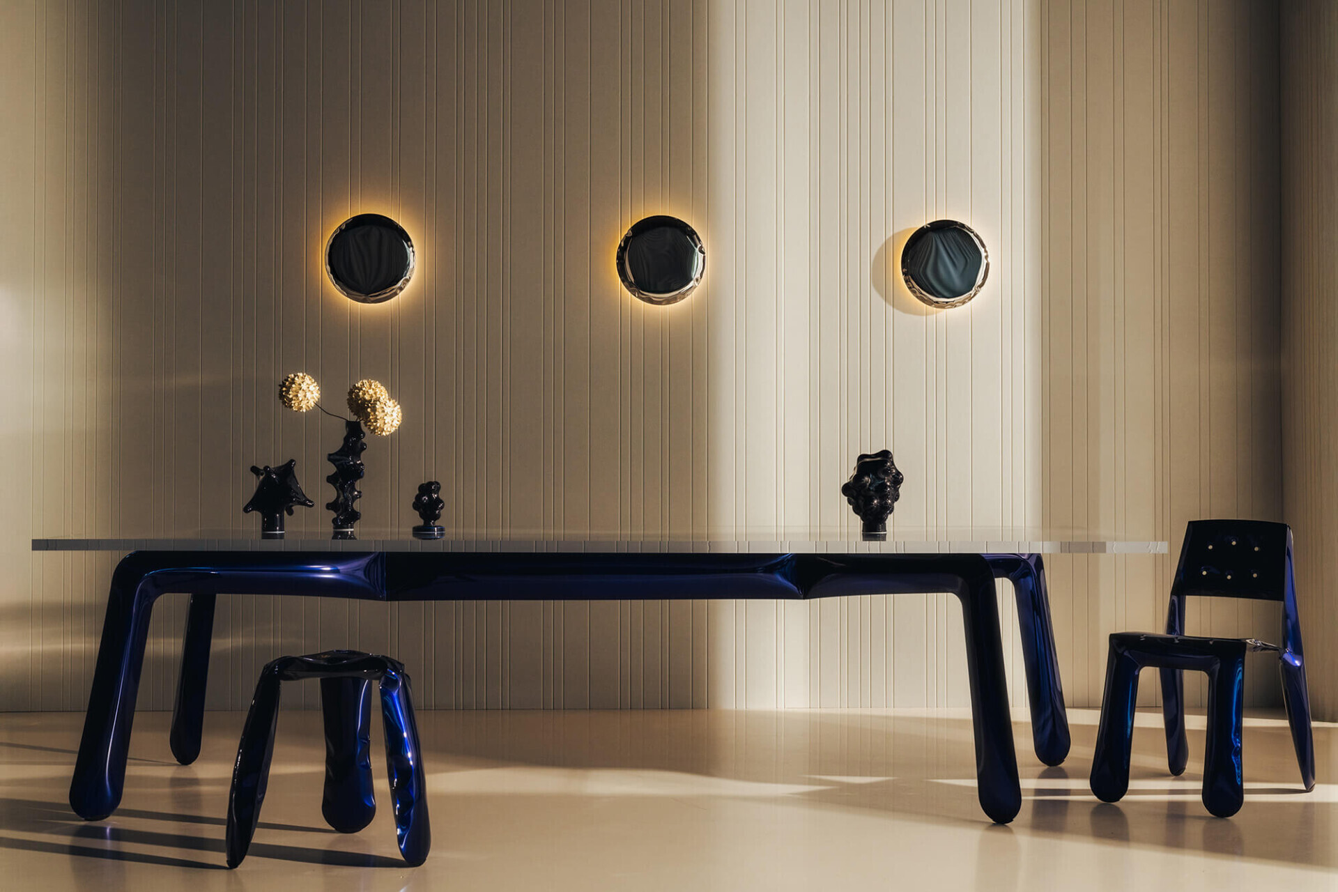 zieta kin inox wall lamps hanging above chippensteel true blue table