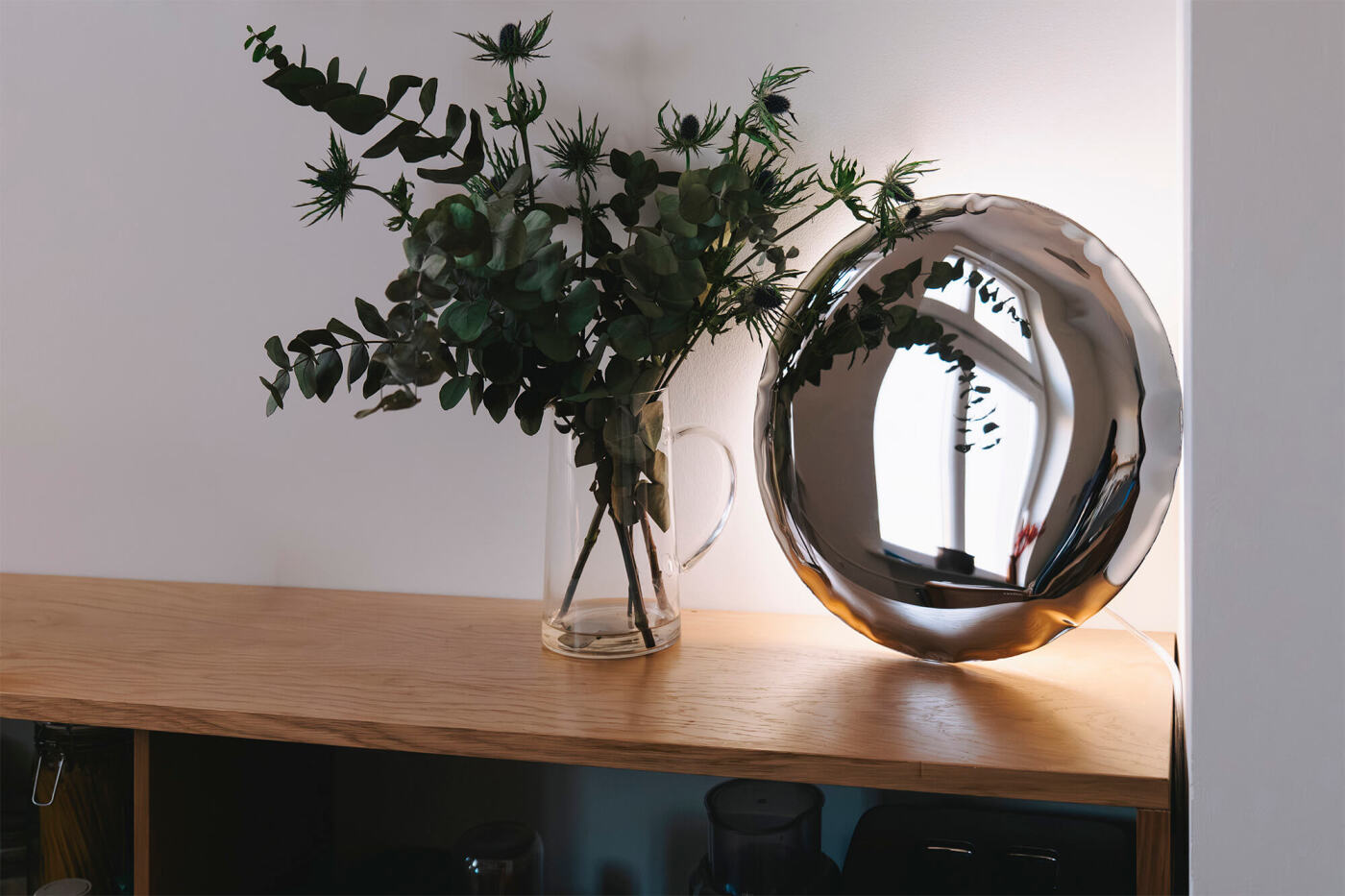 zietai inox kin wall lamp on a dresser