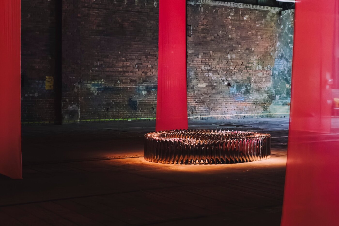 zieta whispers bench surrounded by red curtains