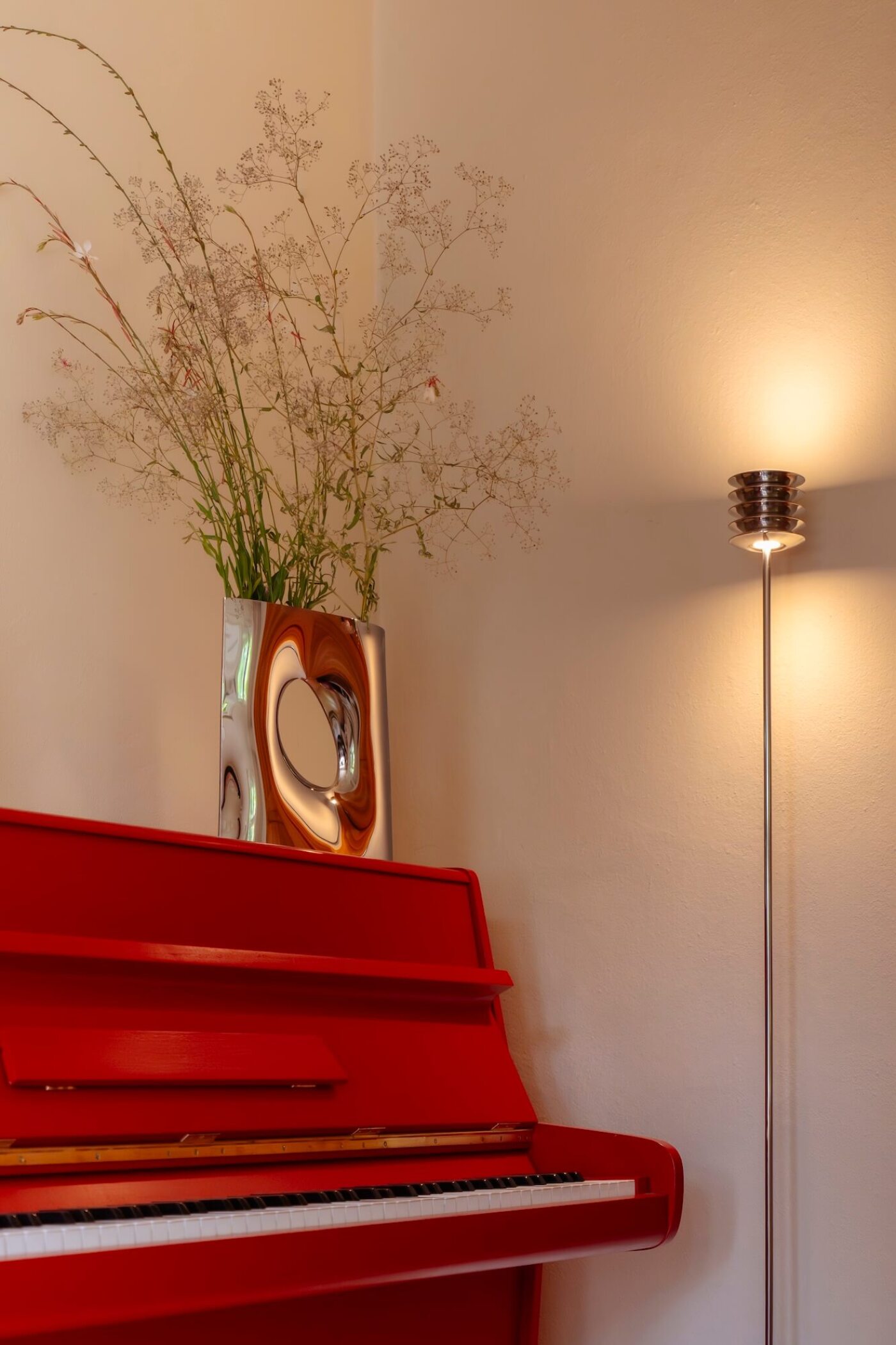 zieta harmonica floor next to a red piano