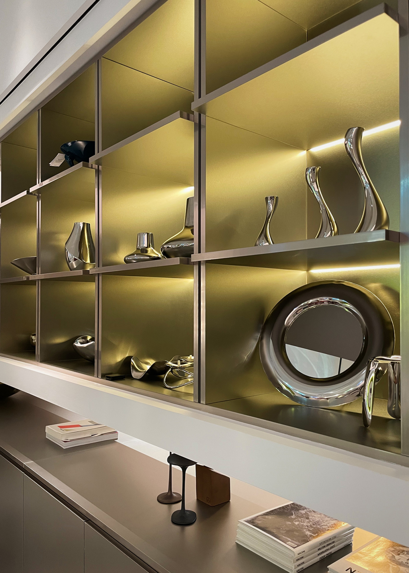 zieta rondel mirror displayed on a shelf with other metal objects
