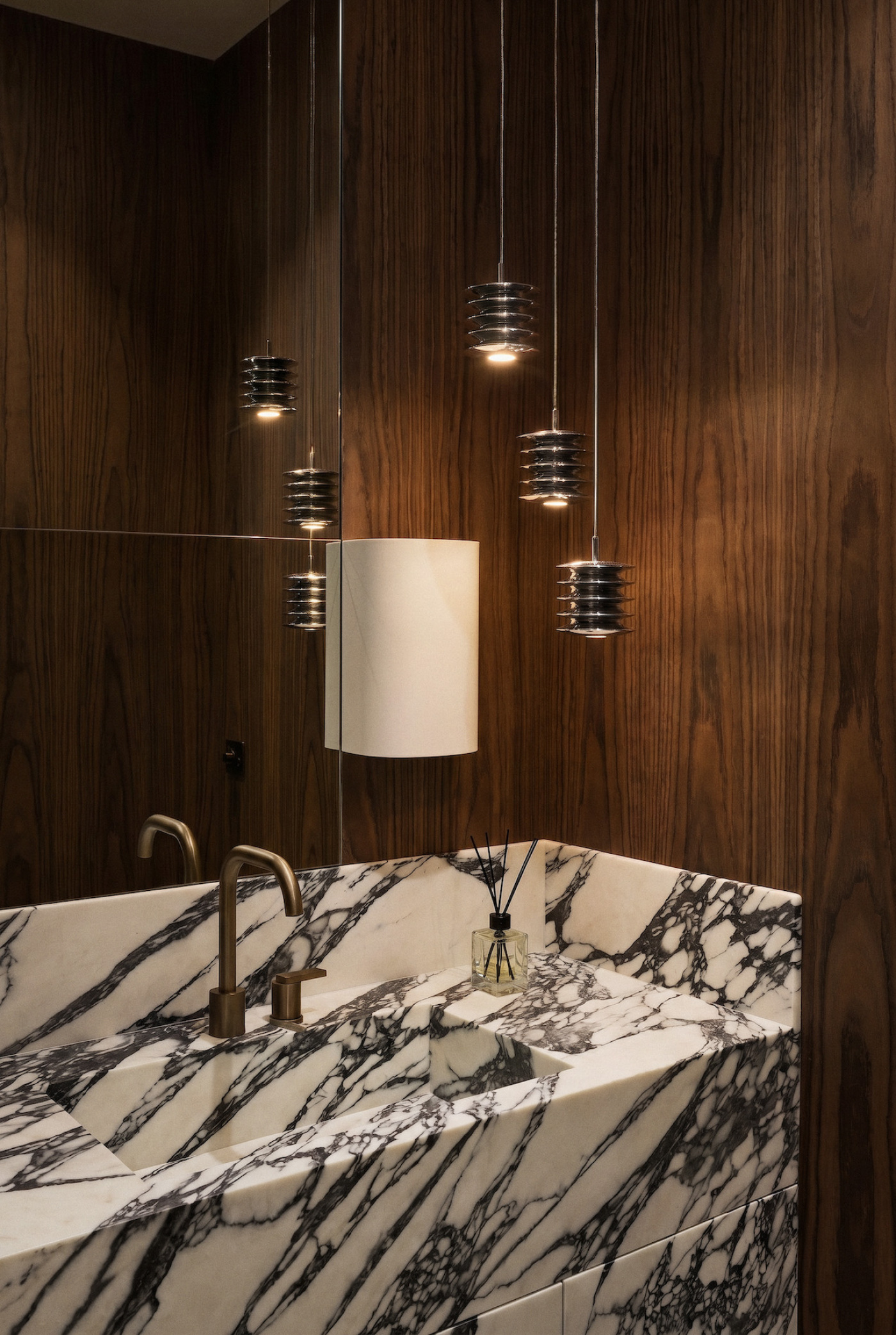 zieta harmonica lamp set in a modern bathroom with wood and stone sink
