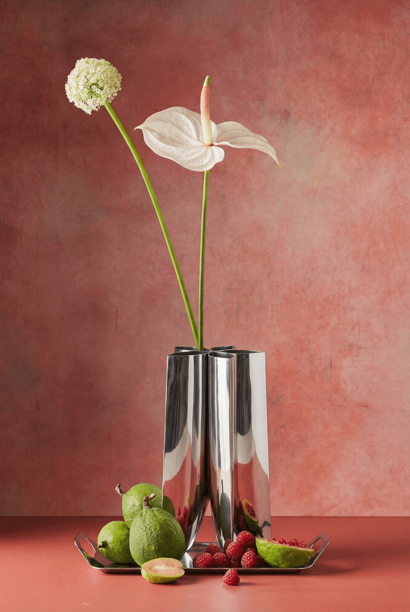 zieta rotation vase with minimalist floral arragement on a dusty pink background