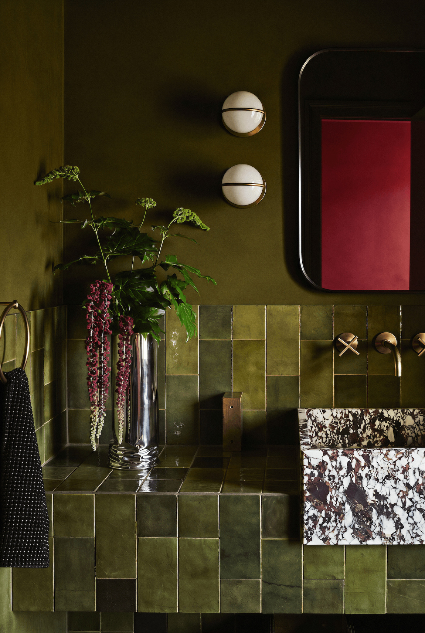 zieta crash vase with flowers in a green bathroom