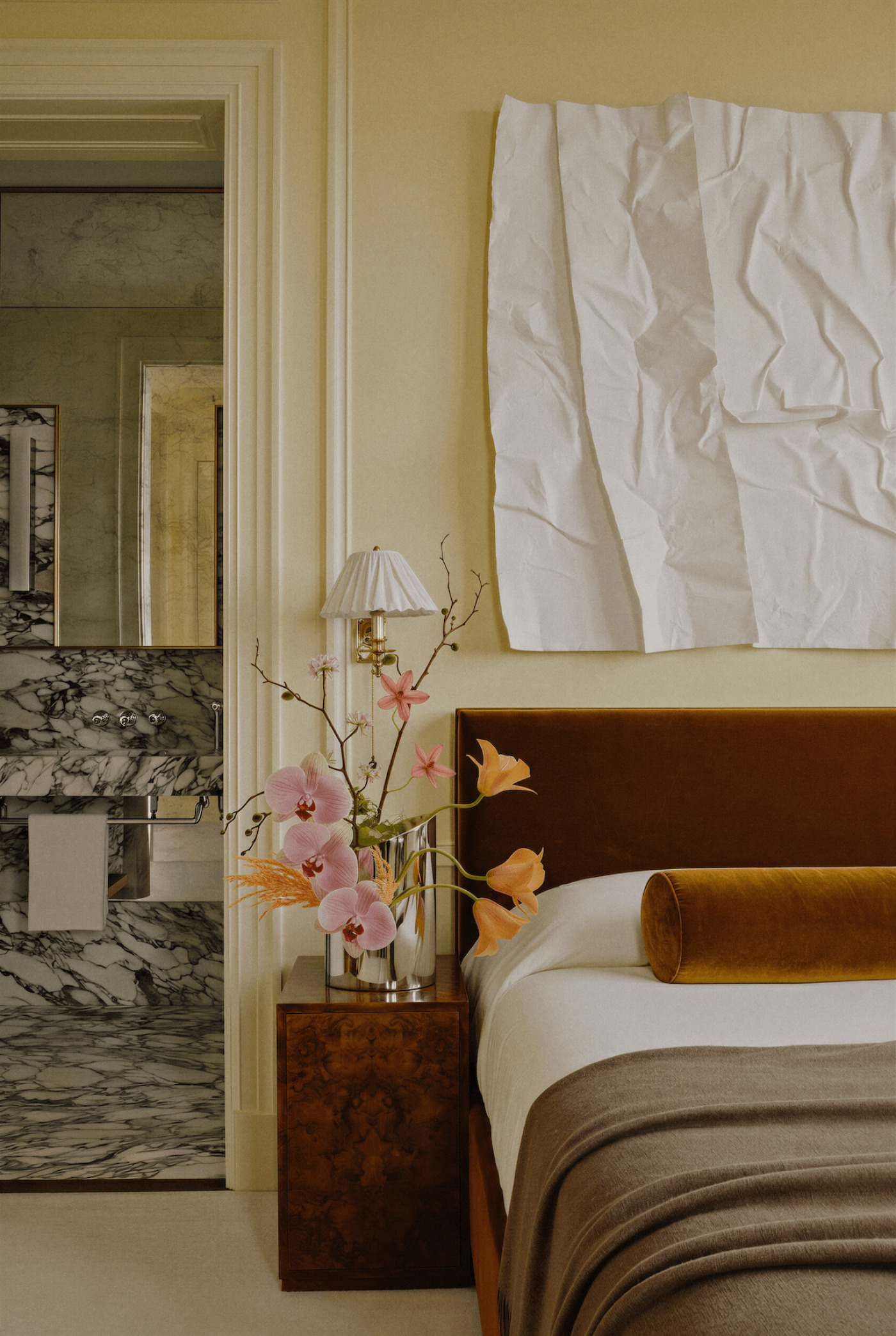zieta parova inox vase in a light bedroom, holding orchid flowers