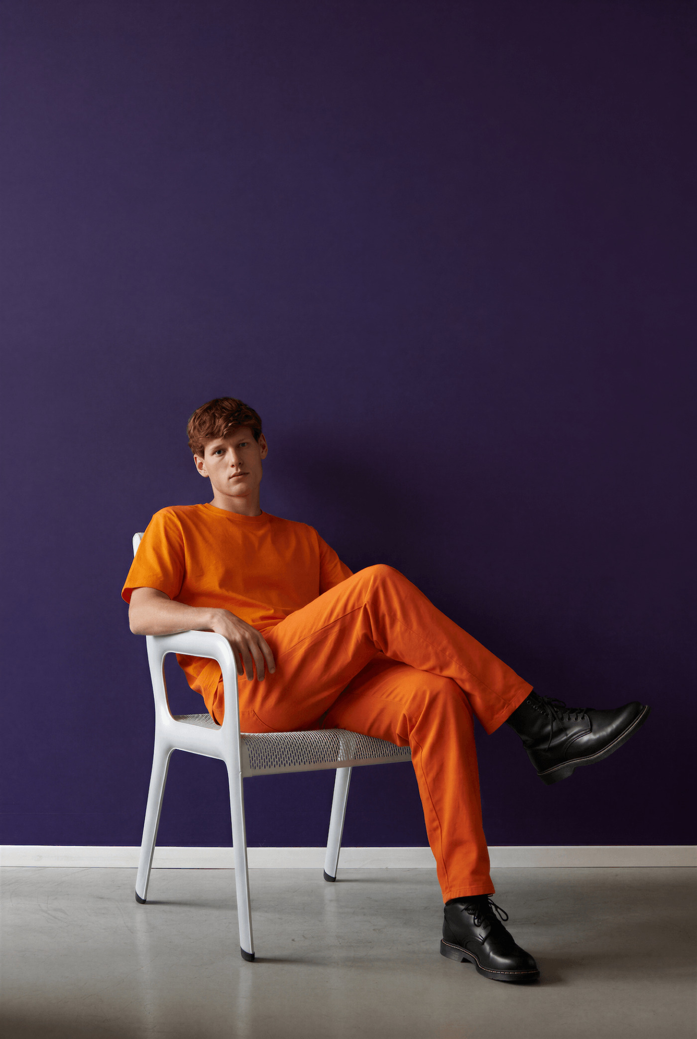 model sitting on white ultraleggera armchair
