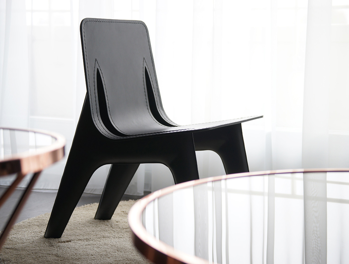 Zieta Studio: J-Chair black brown nogi with leather black obicie, upholstery; minimalist design, refined elegance, sculptural silhouette, premium craftsmanship, timeless aesthetics, soft contrasts, contemporary interior, sophisticated comfort, ponadczasowa estetyka wygodne krzesło
