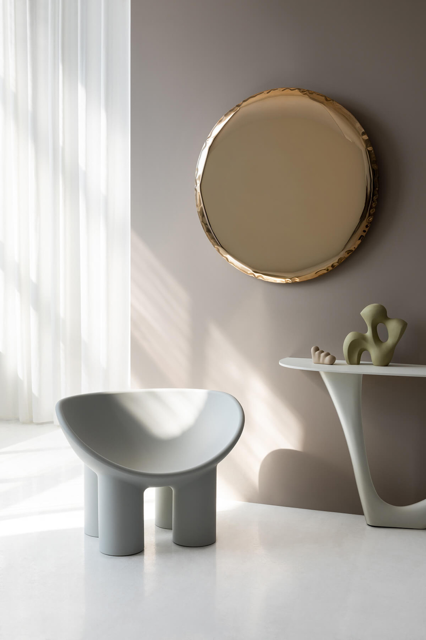 round shaped inflated steel mirror in interior setting