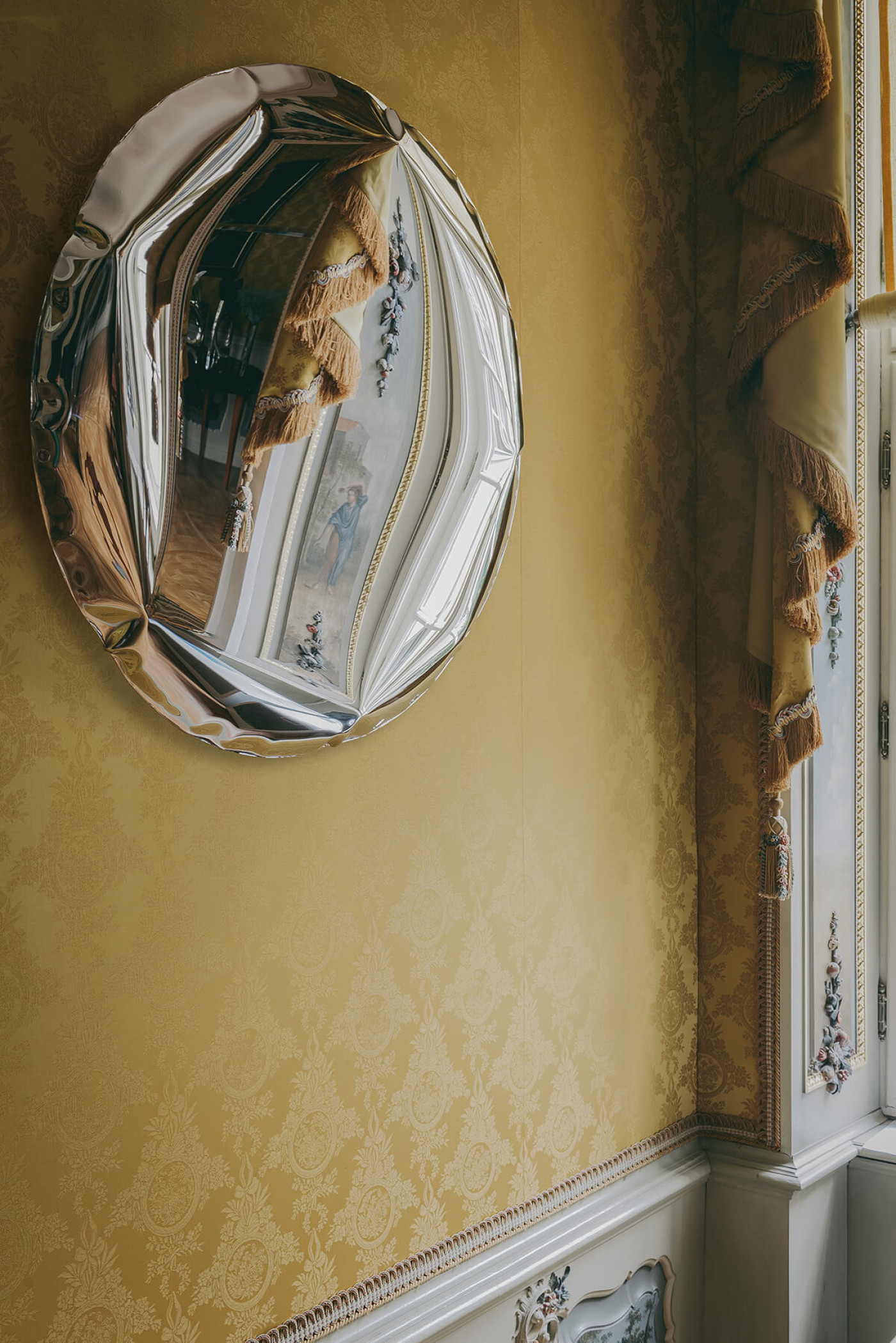 inflated steel mirror with reflections of the room 